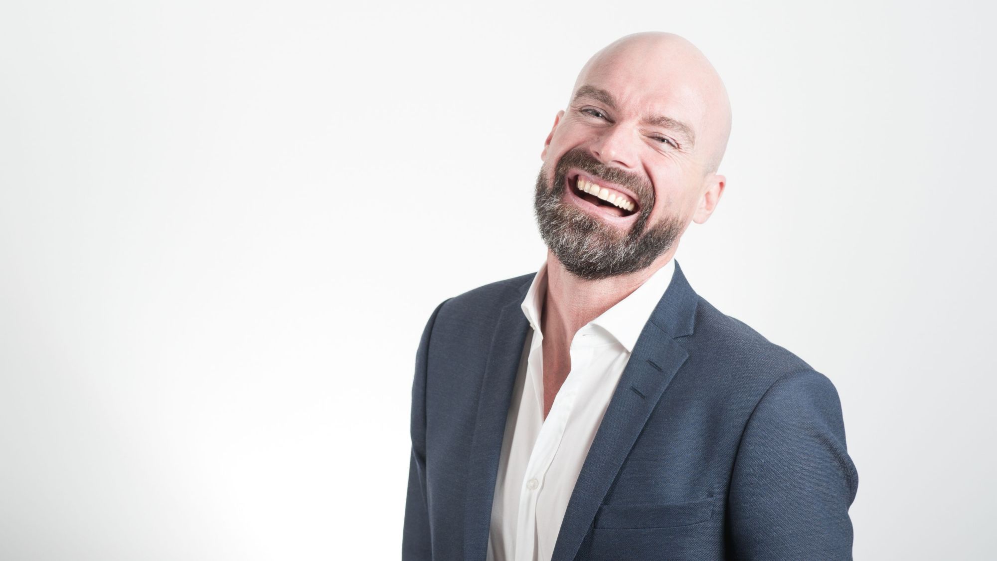 Man laughing in a suit