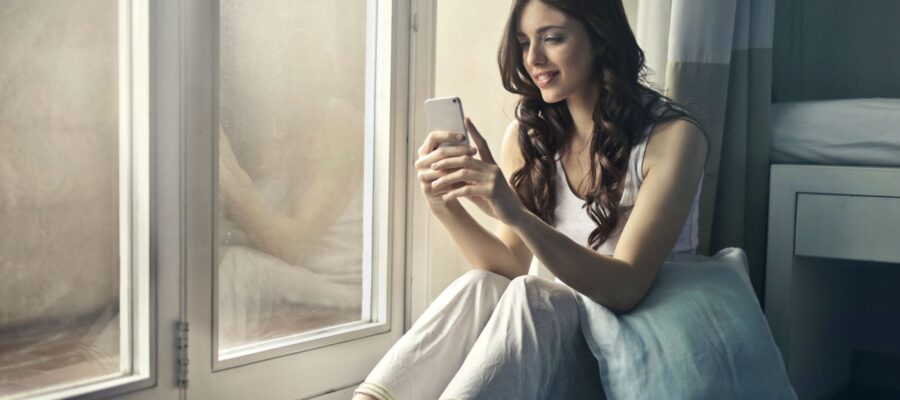 Woman checking her phone near the window