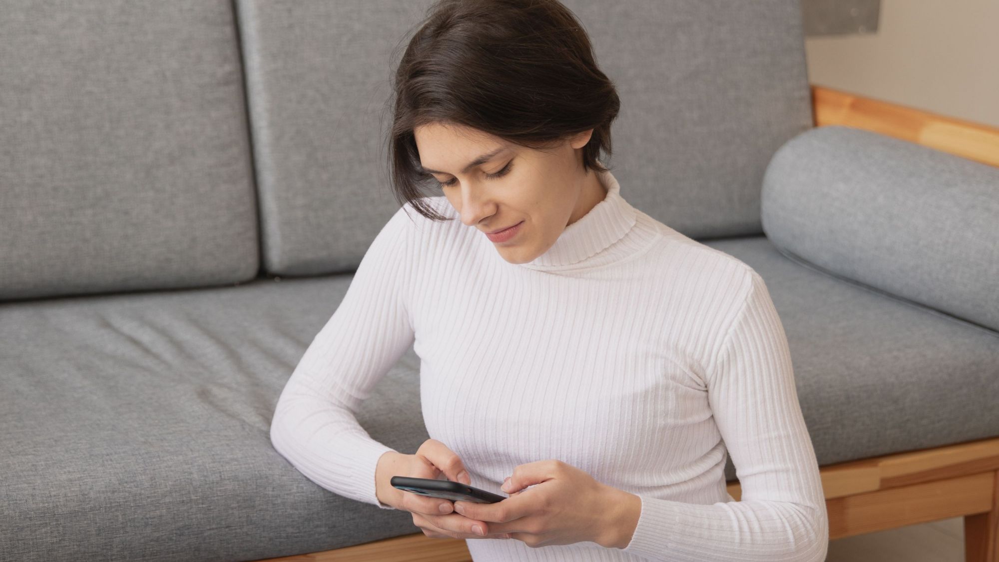 White top woman with mobile 1